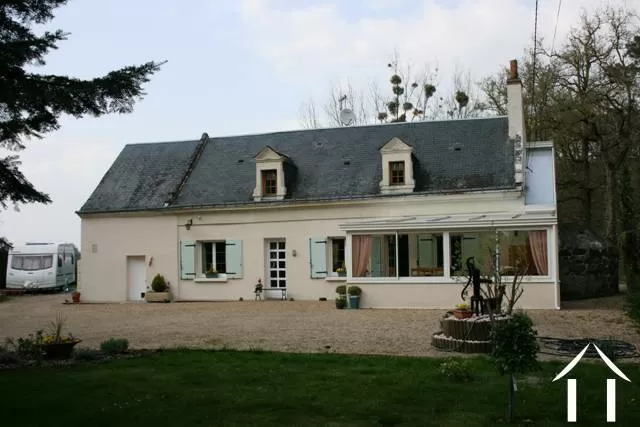 The property is located on a country lane with a number of neighbours (none are too near). This longère is built of tuffeau limestone with a cream enduit (rendering) and an ardoise slate roof. The lucarne windows (dormer windows) are built with dressed tuffeau limestone. 