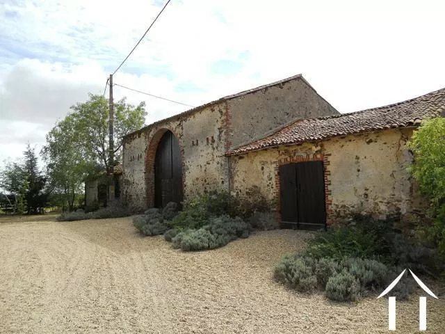 The outbuildings, facing the house and forming part of a sheltered courtyard. 