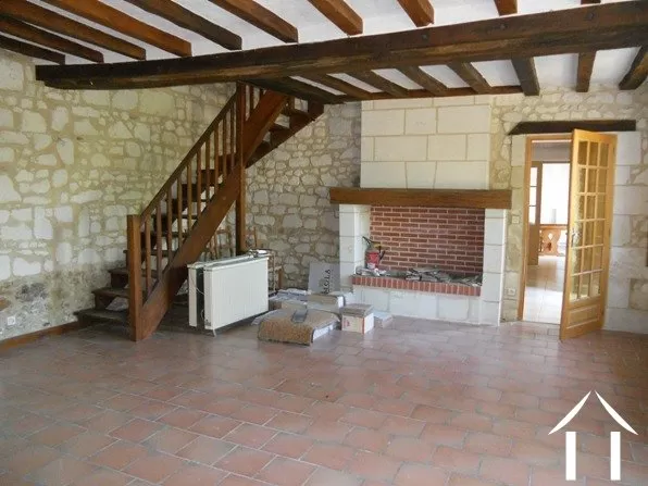 This is the original lounge with its fireplace. From here a staircase rises to two double bedrooms and the large modern family bathroom.