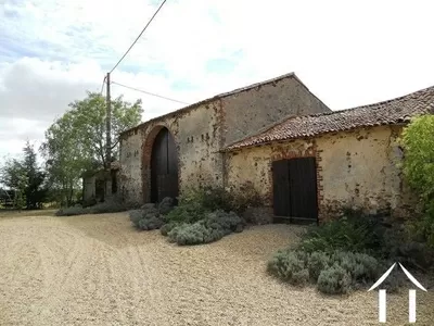 The outbuildings, facing the house and forming part of a sheltered courtyard. 