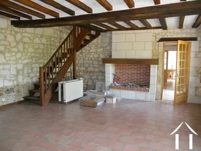 This is the original lounge with its fireplace. From here a staircase rises to two double bedrooms and the large modern family bathroom.
